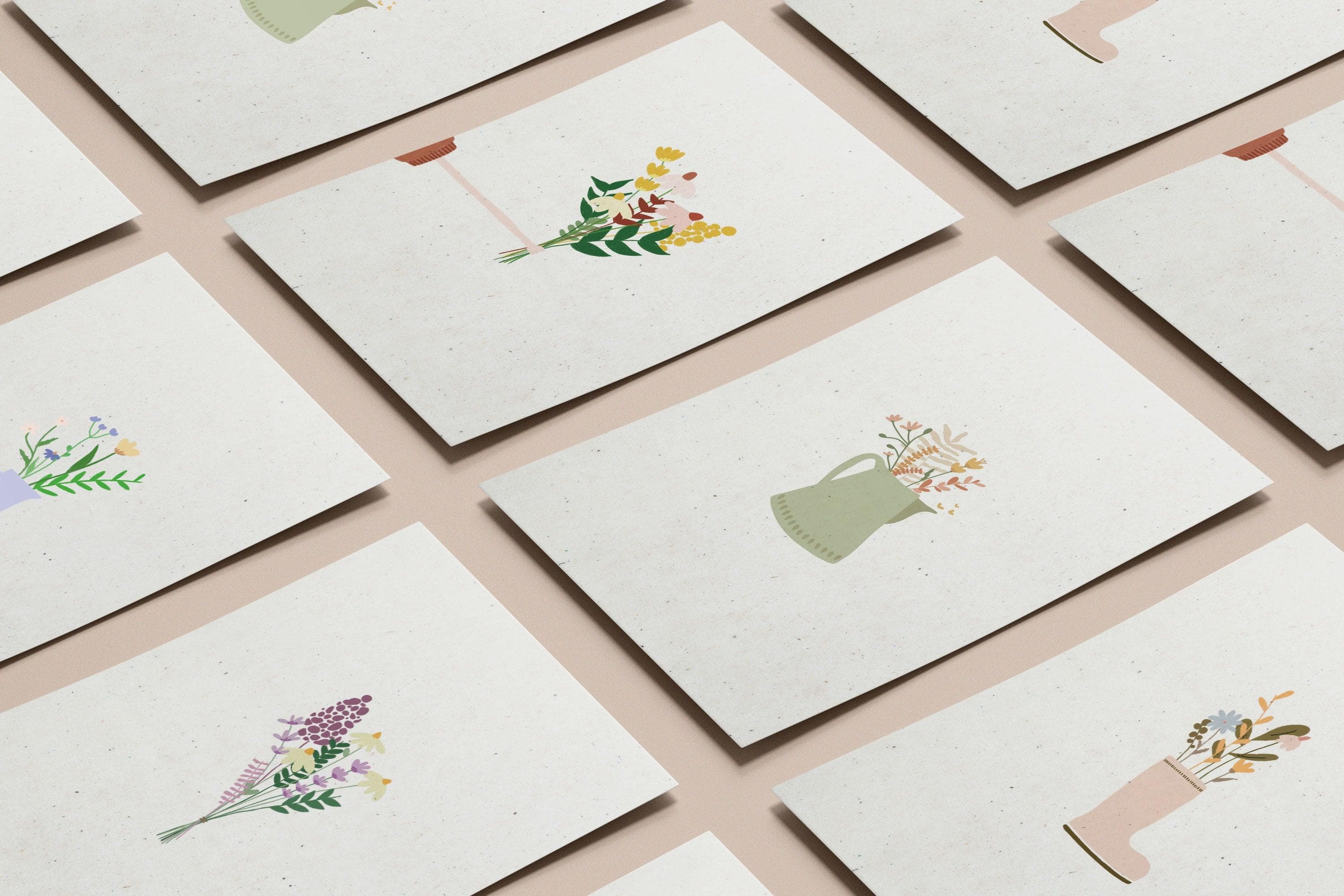 An artist holding botanical art prints at a work table